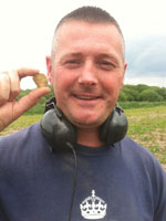 Metal detectorist with his find Metal detectorist with his find