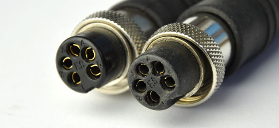 Two GPX metal detector connector plugs - one is new and clean and the other is dirty
