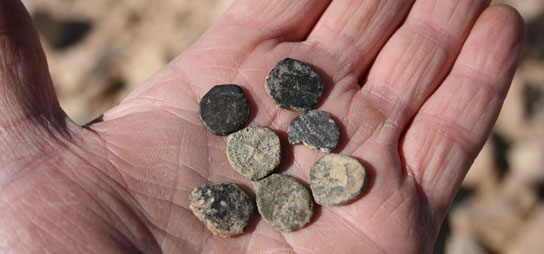 Small corroded Roman coins found with a metal detector in Jordan